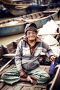 Old man on a boat in river, Vietnam.