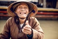 Old man on a boat in river, Vietnam.