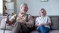 Old man and boy laughing genuinely, joking, valuable fun moments together