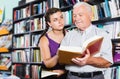 Old man with brunette girl are reading books Royalty Free Stock Photo