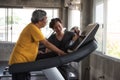 Old man cadio on treadmill with trainer Royalty Free Stock Photo