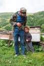 Old man and child, Georgia. Caucasus mountains. Summer season. Royalty Free Stock Photo