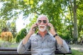 Old man compare two smartphones Royalty Free Stock Photo