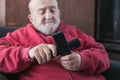 old man confused with tv remote controls Royalty Free Stock Photo