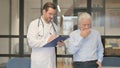 Old Man Coughing while Talking with Doctor Royalty Free Stock Photo