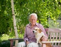 Old man with dog in garden Royalty Free Stock Photo