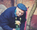 Old man cultivates roses