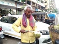 Old man cutting coconut with knife