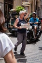 Old man delivering vegetables to local stores in Cefalu, Italy