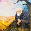 The old man by the desolate fire. Allegory of resentment. Royalty Free Stock Photo