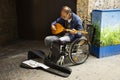 Old man disabled playing Pin Harp music for show German people and foreign travelers on street market in Ostenhellweg road at