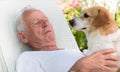 Old man with dog in garden Royalty Free Stock Photo