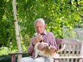 Old man with dog in garden Royalty Free Stock Photo