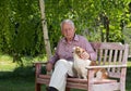 Old man with dog in garden Royalty Free Stock Photo
