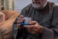 Old man drinking coffee with smile on his face Royalty Free Stock Photo