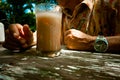 Old man with drinks and stopped time Royalty Free Stock Photo