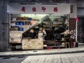 Old man eating lunch in printing press in Hong Kong street