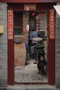 An old man enters his house in a hutong in Beijing, China