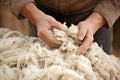 Old man gathers sheared sheep wool from ground on farm yard woven material producing