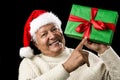 Old Man With Gentle Smile Pointing At Green Gift Royalty Free Stock Photo