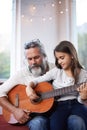 Old man, girl or guitar as teaching, music or training as creative practice for skill development. Grandpa, kid or Royalty Free Stock Photo