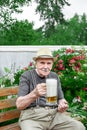 old man with a glass of foamy beer Royalty Free Stock Photo