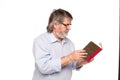 Old man with glasses reading a book Royalty Free Stock Photo