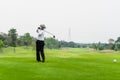 Old man golfing alone on a green golf course. Royalty Free Stock Photo