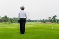 Old man golfing alone on a green golf course. Royalty Free Stock Photo
