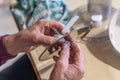 Old man grandpa with hands builds assembled disassembles a kitchen mashine into the parts, Germany