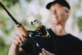 Old Man with Gray Hair Fishing on River in Summer.