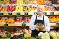 Old man green grocer worker standing with melon in hands Royalty Free Stock Photo
