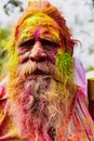 Old man with grey beard covered in Holi paint colors Royalty Free Stock Photo