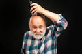 Old man with hair clipper isolated on black. Bald man hairclipper, Mature baldness and hair loss concept.