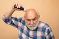 Old man hair treatment. Gray man hair clippings. Bald man hairclipper, Mature baldness and hair loss concept. Royalty Free Stock Photo