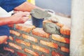 Old man Hand white-wash cement built wall brick new house, Brick Royalty Free Stock Photo