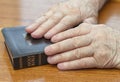 Old man hands on bible Royalty Free Stock Photo