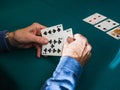 Old man hands playing cards in home Royalty Free Stock Photo