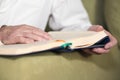 An old man hands reading Koran. Selective focus Royalty Free Stock Photo