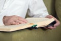 An old man hands reading Koran. Selective focus Royalty Free Stock Photo