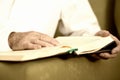 An old man hands reading the Koran. Selective focus Royalty Free Stock Photo