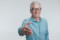 old man in his 60s with glasses shaking hand and introducing himself Royalty Free Stock Photo