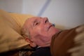 Old man lying in bed Royalty Free Stock Photo