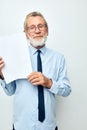 old man holding documents with a sheet of paper light background Royalty Free Stock Photo