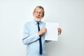 old man holding documents with a sheet of paper light background Royalty Free Stock Photo