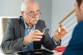 old man holding magnifying glass and magnifying viewer ring Royalty Free Stock Photo