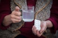 An old man holds an aspirin in his hands. Royalty Free Stock Photo