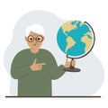 A old man holds a globe in his hand and points his finger at it. The concept of education, teacher, world conquest Royalty Free Stock Photo