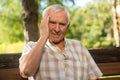 Old man holds his head. Royalty Free Stock Photo