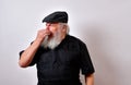 Old man holds nose from bad smell
